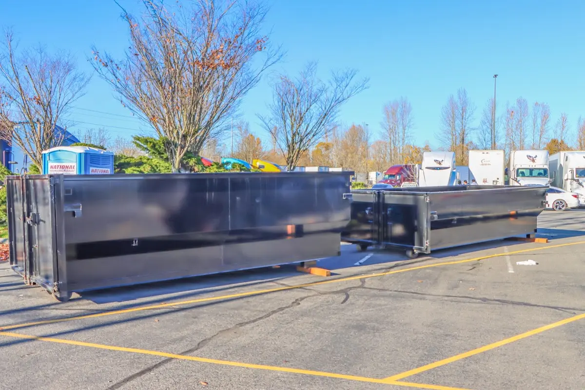 Professional dumpster rental service with roll-off container on residential driveway in Indiana